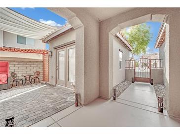 Inviting outdoor patio with brick flooring, covered seating, and access to the home at 952 Contadero Pl, Las Vegas, NV 89138