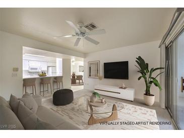 Bright living room features a ceiling fan, and a view into the kitchen at 2725 S Nellis Blvd # 1096, Las Vegas, NV 89121
