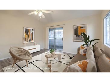 Virtually staged living room with sliding door to balcony at 2725 S Nellis Blvd # 2096, Las Vegas, NV 89121