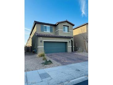 Two-story home featuring a two-car garage, low maintenance yard, and neutral color palette at 8279 Palladium St, Las Vegas, NV 89113