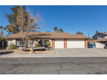 House exterior with a three car garage at 3544 Sandcliff Ln, Las Vegas, NV 89121