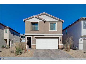 Two-story house with a white garage door and landscaping at 4132 Spring Storm Ave, North Las Vegas, NV 89081