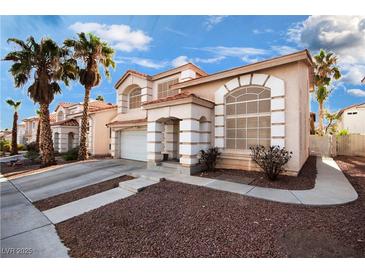 Inviting two-story home boasts stylish architecture, desert landscaping, palm trees and a two car garage at 8737 Autumn Valley Ave, Las Vegas, NV 89129