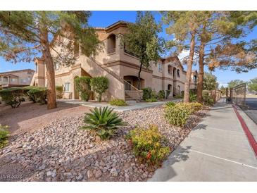 Two-story condo building with landscaping and gated entrance at 5751 E Hacienda Ave # 107, Las Vegas, NV 89122