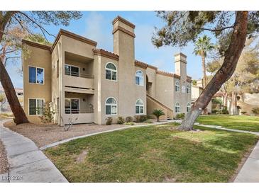 Two-story building with Spanish-style architecture, landscaping, and walkways at 3145 E Flamingo Rd # 1045, Las Vegas, NV 89121