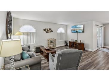 Inviting living room with cozy furniture, modern decor, and wood flooring at 3145 E Flamingo Rd # 1045, Las Vegas, NV 89121