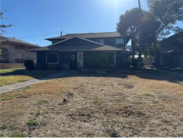 Two-story building with a dark blue exterior and a grassy yard at 1521 Elizabeth Ave # 4, Las Vegas, NV 89119