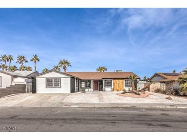 Newly renovated single story home with a modern facade and landscaped front yard at 4754 Monterrey Ave, Las Vegas, NV 89121