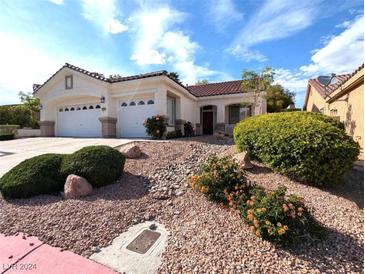 Charming single story home with a two car garage and meticulously landscaped front yard at 9728 Echo Hills Dr, Las Vegas, NV 89134