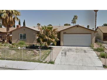 One-story house with attached garage and landscaped front yard at 3698 Rawhide Ct, Las Vegas, NV 89120