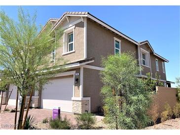 Two-story townhome with attached garage and landscaping at 114 Antler Square Ln, Henderson, NV 89011