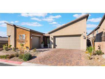 Two-story home with attached two-car garage and landscaped front yard at 16 Via Stefano, Henderson, NV 89011