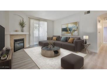 Bright living room features a fireplace and comfortable seating at 1830 N Buffalo Dr # 1091, Las Vegas, NV 89128