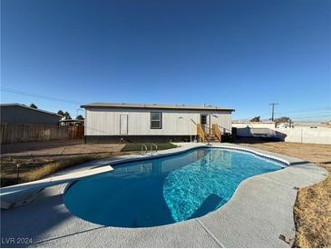 Inviting backyard with a sparkling pool and diving board at 2028 College Pl, Las Vegas, NV 89156