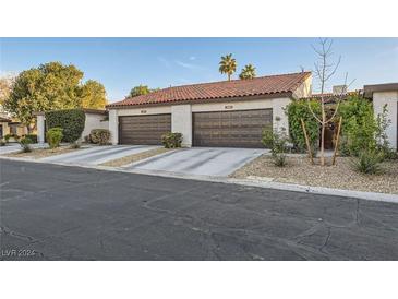 Three-unit complex with attached garages and desert landscaping at 3143 Sonata Dr, Las Vegas, NV 89121