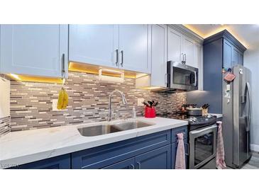 Modern kitchen with stainless steel appliances and stylish blue cabinets at 4950 Larkspur St, Las Vegas, NV 89120