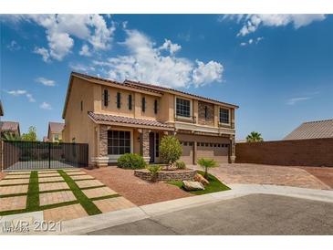 Two-story house with a landscaped yard and a three-car garage at 5728 Collier Falls Ave, Las Vegas, NV 89139