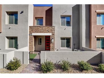 Modern two-story townhome with stone accents and a red door at 600 N Carriage Hill Dr # 1113, Las Vegas, NV 89138