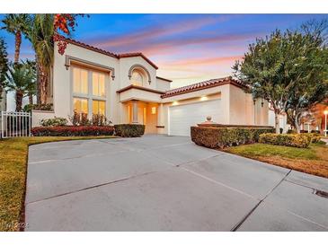 Stunning two-story home featuring desert landscaping and a spacious driveway at 8390 Carmel Ridge Ct, Las Vegas, NV 89113