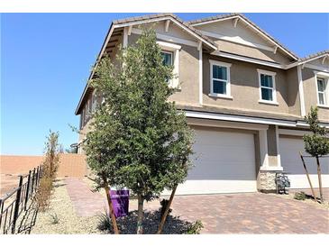 Two-story house with attached garage and landscaping at 112 Antler Square Ln, Henderson, NV 89011