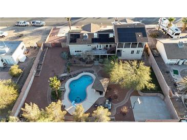 Expansive backyard featuring a pool, slide, gazebo, basketball court, and solar panels on house roof at 260 E Desert Rose Dr, Henderson, NV 89015