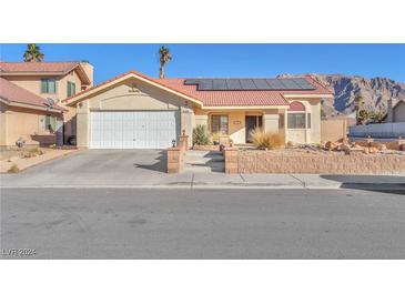 Single-story home with solar panels and landscaped yard at 1550 Desertaire Way, Las Vegas, NV 89110