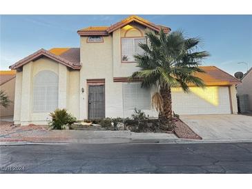 Two-story house with tile roof, attached garage, and palm tree at 2732 Sesame Dr, Las Vegas, NV 89142