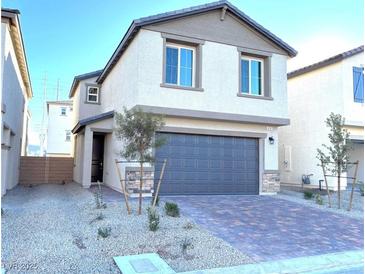 Two-story house with a two-car garage and landscaped front yard at 4747 Illustria Ave, Las Vegas, NV 89141