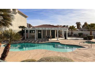 Community pool area with well-maintained landscaping and seating, perfect for relaxing and enjoying the outdoors at 6201 E Lake Mead Blvd # 216, Las Vegas, NV 89156