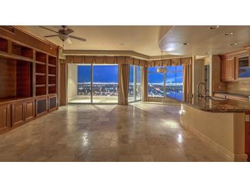 Spacious living room with city views and built-in shelving at 9101 Alta Dr # 1406, Las Vegas, NV 89145