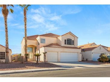 Two-story house with three-car garage, and palm trees in front at 3837 Willowview Ct, Las Vegas, NV 89147