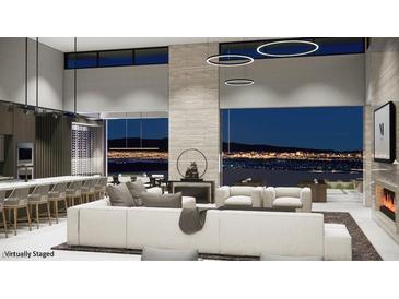Modern living room featuring an open floorplan, large windows with city views, and stylish furniture at 495 Cityview Ridge Dr, Henderson, NV 89012