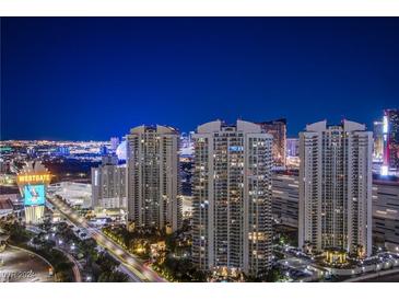 Striking night view of the Las Vegas Strip featuring high-rise condos and vibrant city lights at 222 Karen Ave # 3907, Las Vegas, NV 89109