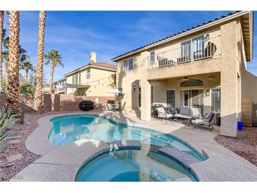 Inviting backyard oasis featuring a sparkling pool and spa, perfect for relaxation at 11009 Pentland Downs St, Las Vegas, NV 89141