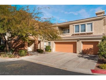 Inviting two-story home with a three-car garage and mature landscaping at 10710 Destination Ln # 201, Las Vegas, NV 89144