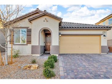 Single-story house with neutral colors, landscaping, and a two-car garage at 145 Langley Hill Ave, Henderson, NV 89002