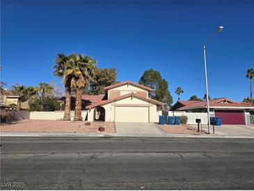 Single-story house with palm trees and a two-car garage at 5882 W Viking Rd, Las Vegas, NV 89103