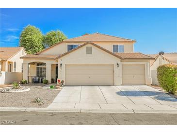 Two-story house with three-car garage and desert landscaping at 841 Glitter Glen Ct, Las Vegas, NV 89123