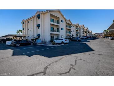 Well-maintained condo building featuring ample parking and private balconies with awnings and mountain views at 3550 Bay Sands Dr # 2076, Laughlin, NV 89029