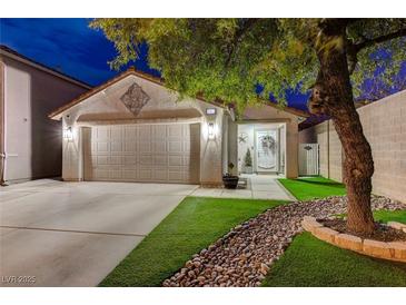 Night view of charming house with artificial turf and stone landscape at 6341 W Haleh Ave, Las Vegas, NV 89141