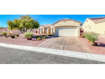 Single-story house with a two-car garage and well-manicured landscaping at 2313 Fox Hills Dr, Henderson, NV 89052