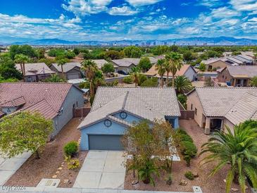Charming single-story home in a community featuring a two-car garage and desert landscaping at 3591 Driving Range St, Las Vegas, NV 89122