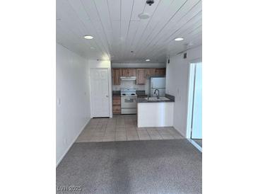 Charming kitchen with tiled floors, modern appliances, and plenty of storage space at 1381 E University Ave # 102, Las Vegas, NV 89119