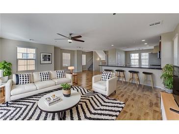 Bright living room features a modern ceiling fan, plush seating, and stylish black and white accents at 366 Ambitious St, Henderson, NV 89011