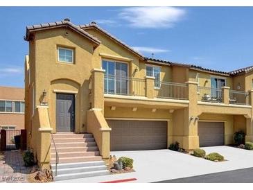 Tan two-story townhome with attached two-car garage and balcony at 1160 Via Laterna, Henderson, NV 89052