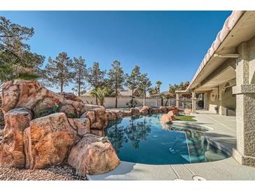 Inviting pool with a rock waterfall feature and a spacious patio area at 3245 W Landberg Ave, Las Vegas, NV 89141