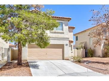 Two-story house with beige exterior, attached garage, and landscaping at 10168 Maidens Wreath Ct, Las Vegas, NV 89183