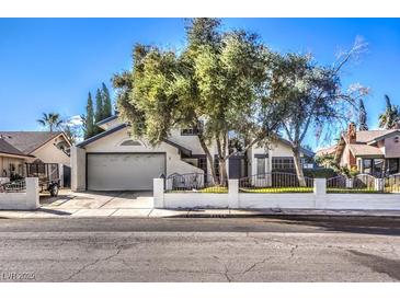 Single-story house with a gray garage door and a well-maintained lawn at 4705 Rockvale Dr, Las Vegas, NV 89103