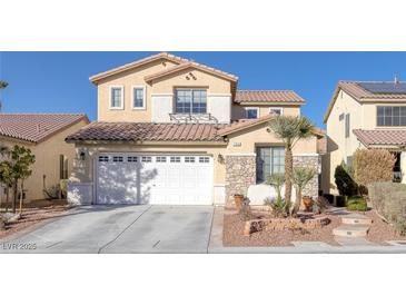 Two-story house with a white garage door and landscaping at 734 Holland Heights Ave, Las Vegas, NV 89123