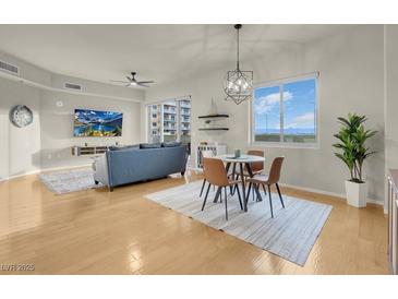 Open living area with hardwood floors, dining area, and modern lighting at 8255 One Las Vegas Blvd # 504, Las Vegas, NV 89123